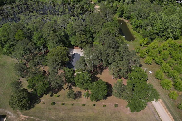 birds eye view of property with a wooded view
