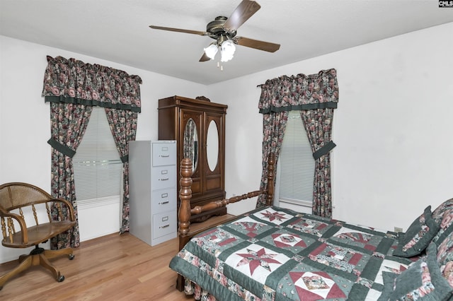 bedroom with light wood-style flooring and a ceiling fan