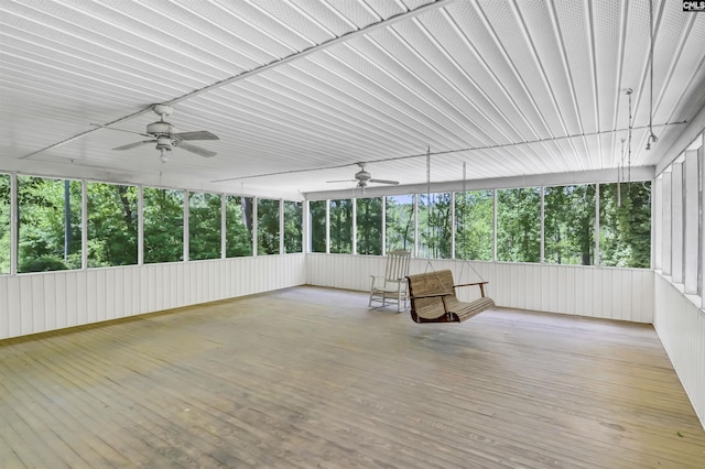 unfurnished sunroom with ceiling fan