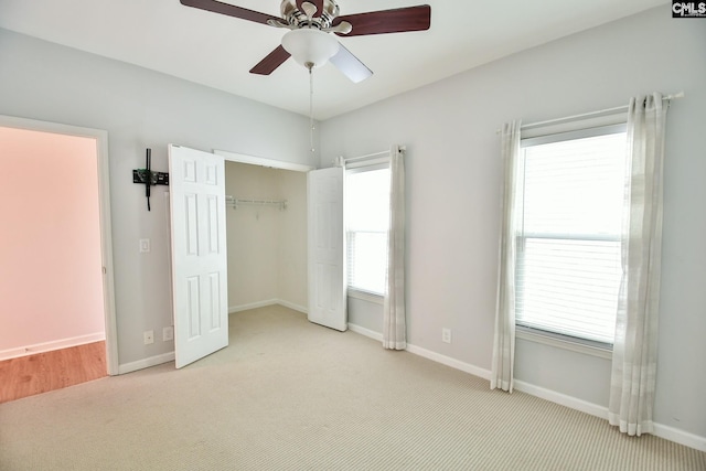 unfurnished bedroom featuring ceiling fan, carpet, a closet, and baseboards