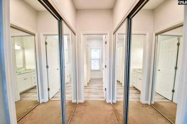 hallway featuring light carpet