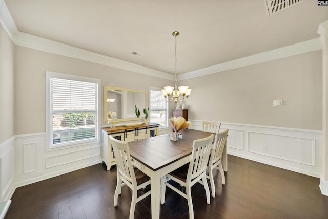 dining area with a chandelier, visible vents, and wainscoting