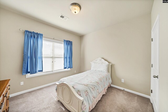 bedroom with carpet floors, baseboards, and visible vents