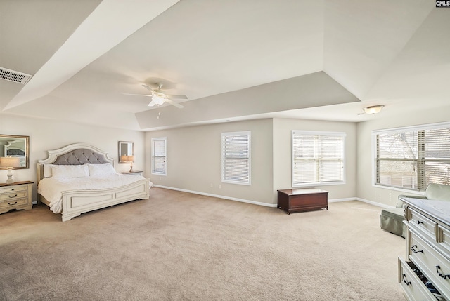 bedroom with light carpet, baseboards, visible vents, and multiple windows