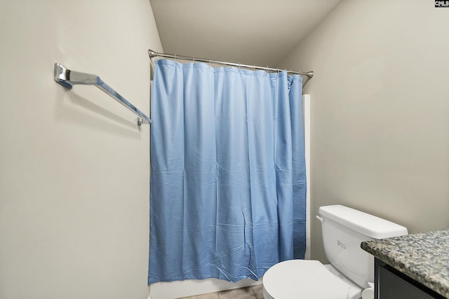 bathroom featuring vanity, toilet, and a shower with curtain