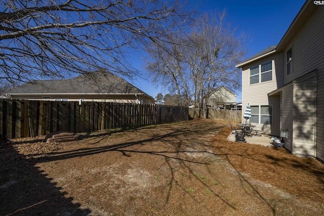 view of yard featuring a patio area and a fenced backyard