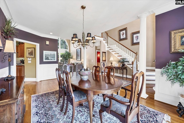 212 Cartgate Cir, Blythewood, SC 29016 - dining space with a chandelier, a wainscoted wall, light wood-type flooring, and stairway