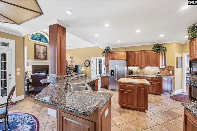 212 Cartgate Cir, Blythewood, SC 29016 - kitchen featuring light tile patterned floors, a sink, stainless steel fridge with ice dispenser, a center island with sink, and tasteful backsplash