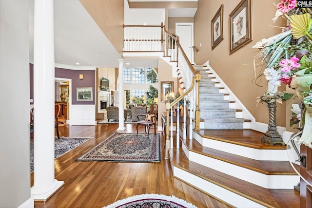 212 Cartgate Cir, Blythewood, SC 29016 - foyer with ornamental molding, stairs, wood finished floors, a fireplace, and ornate columns