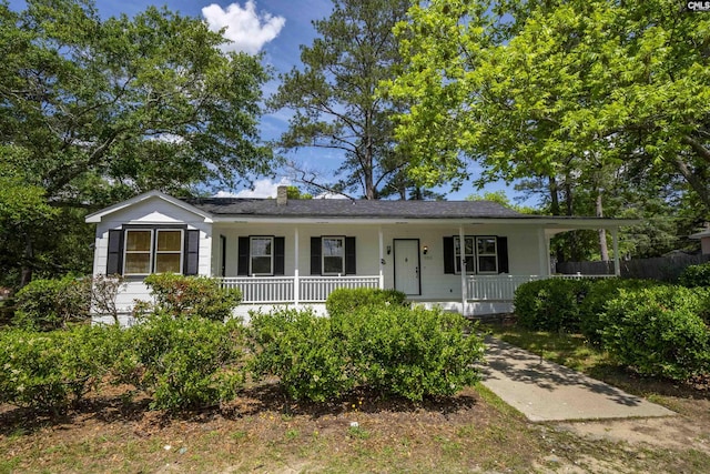 view of front of property with a porch and a chimney