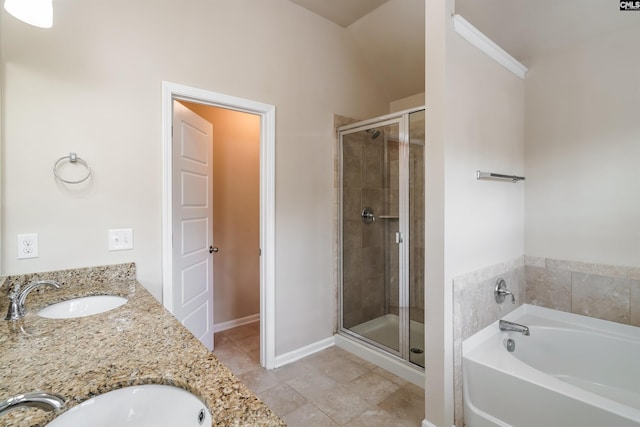 full bathroom with a garden tub, a shower stall, and a sink