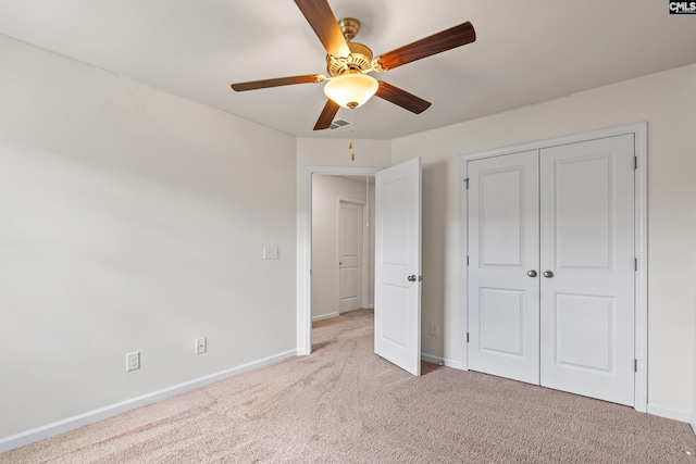 unfurnished bedroom with carpet flooring, baseboards, and a closet