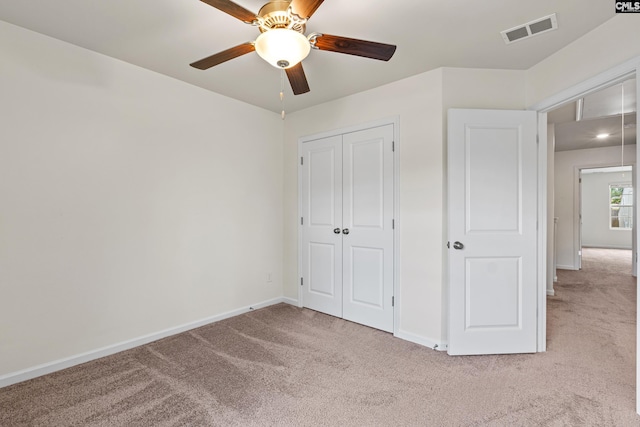 unfurnished bedroom with carpet floors, baseboards, a closet, and ceiling fan