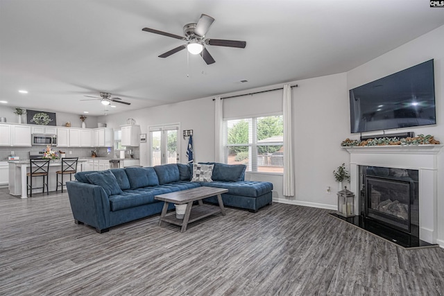 living room with ceiling fan, wood finished floors, a premium fireplace, recessed lighting, and baseboards