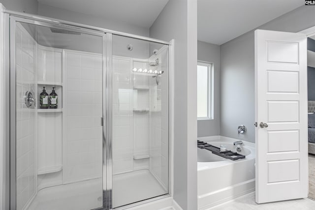 full bathroom featuring ensuite bath, a stall shower, and a bath