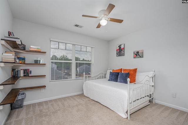 carpeted bedroom with baseboards and a ceiling fan