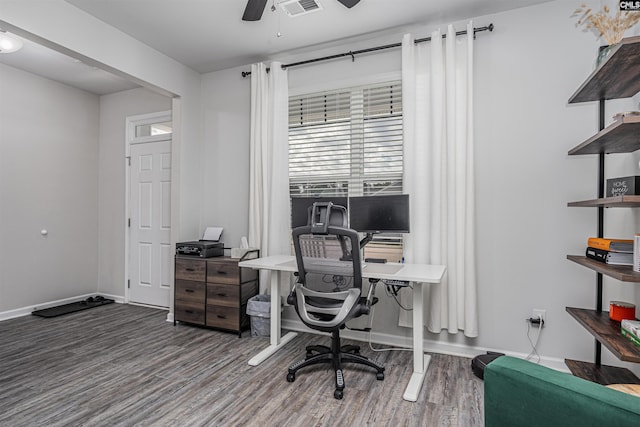 home office with wood finished floors, ceiling fan, and baseboards
