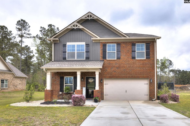 craftsman inspired home featuring a front lawn, an attached garage, concrete driveway, and brick siding