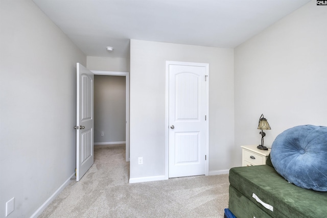 sitting room with light colored carpet and baseboards