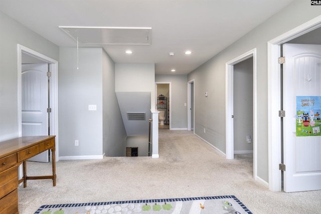 hallway featuring attic access, an upstairs landing, carpet, recessed lighting, and baseboards