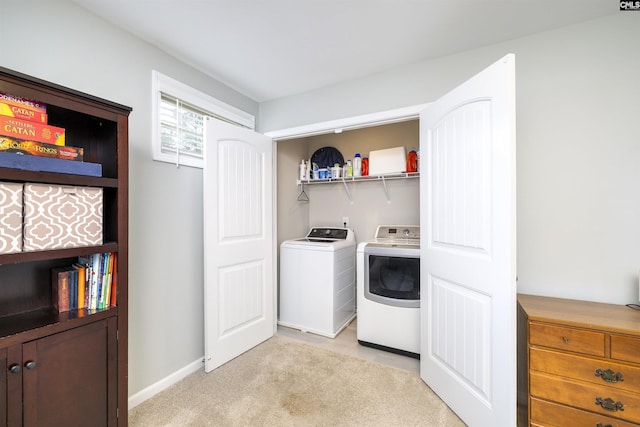clothes washing area featuring independent washer and dryer and baseboards