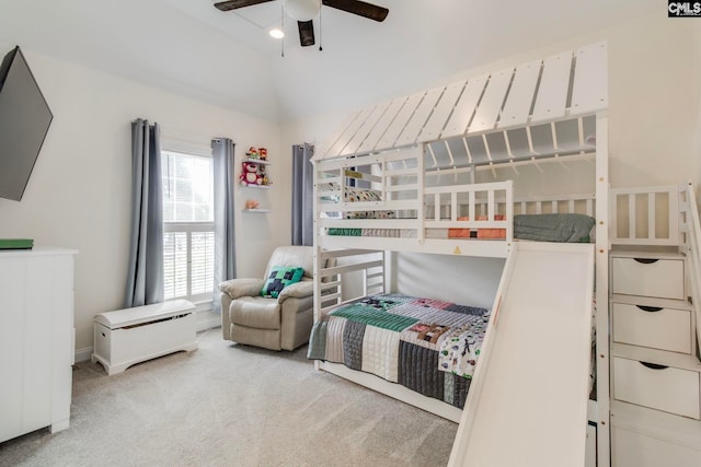 carpeted bedroom featuring ceiling fan and vaulted ceiling
