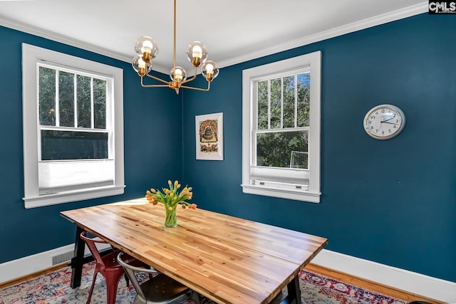 307 Waccamaw Ave, Columbia, SC 29205 - dining area with baseboards, a chandelier, wood finished floors, and ornamental molding