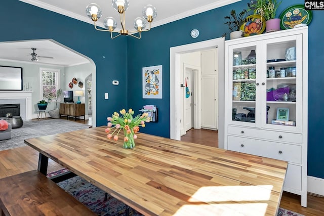 307 Waccamaw Ave, Columbia, SC 29205 - dining room featuring crown molding, wood finished floors, a chandelier, arched walkways, and a ceiling fan