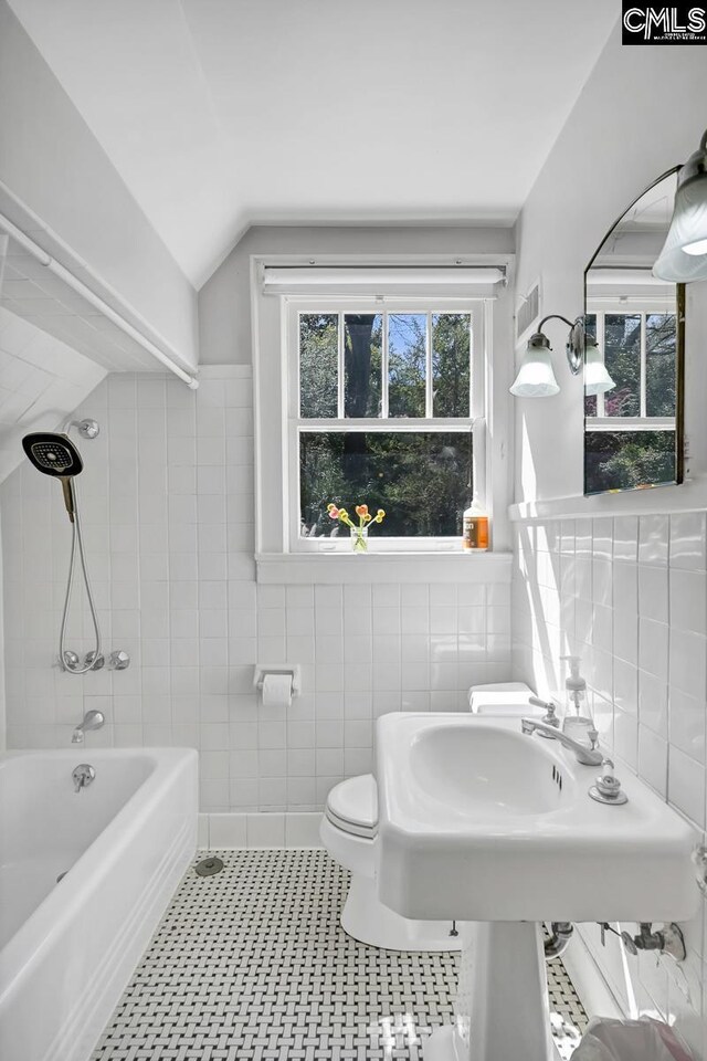 307 Waccamaw Ave, Columbia, SC 29205 - bathroom featuring tile walls, toilet, vaulted ceiling, and tub / shower combination