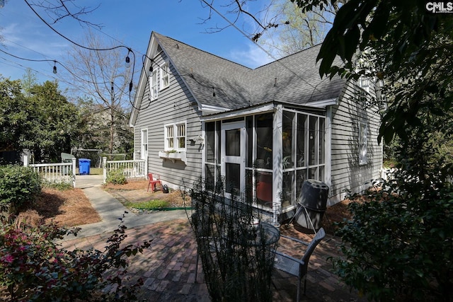 307 Waccamaw Ave, Columbia, SC 29205 - view of home's exterior with roof with shingles, a sunroom, and a patio area