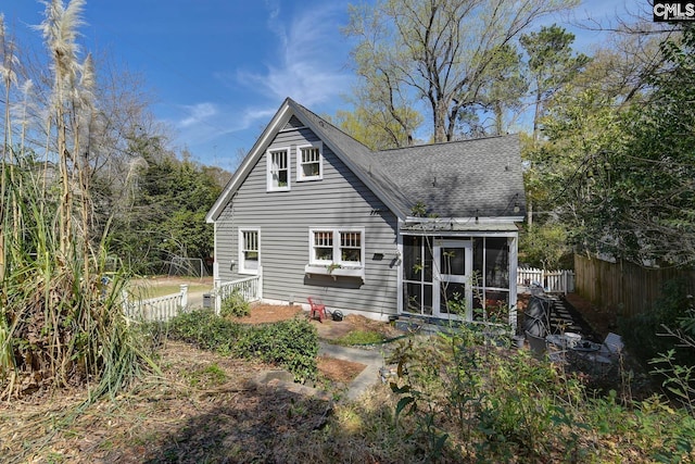 307 Waccamaw Ave, Columbia, SC 29205 - back of house featuring a sunroom, roof with shingles, and fence