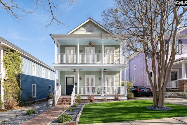 2408 Park St, Columbia, SC 29201 - view of front facade with ceiling fan, a porch, a balcony, a front yard, and french doors