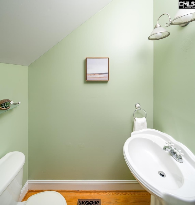 2408 Park St, Columbia, SC 29201 - half bath with a sink, toilet, baseboards, and vaulted ceiling