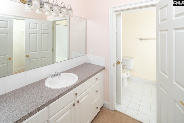2408 Park St, Columbia, SC 29201 - bathroom featuring toilet, baseboards, vanity, and tile patterned floors