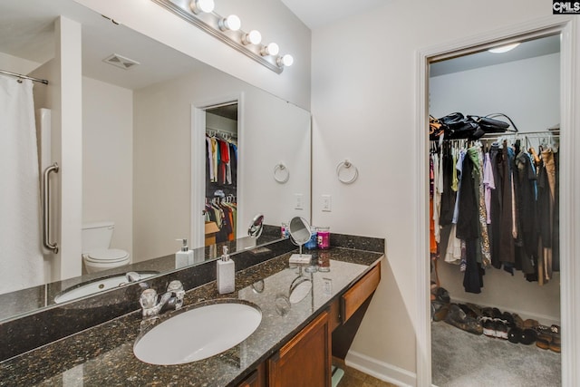393 Vermillion Dr, Columbia, SC 29209 - bathroom featuring vanity, toilet, a spacious closet, baseboards, and a shower with shower curtain