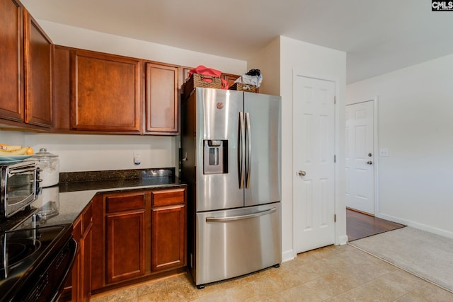 393 Vermillion Dr, Columbia, SC 29209 - kitchen with stainless steel fridge with ice dispenser, dark stone counters, black electric range oven, brown cabinets, and baseboards