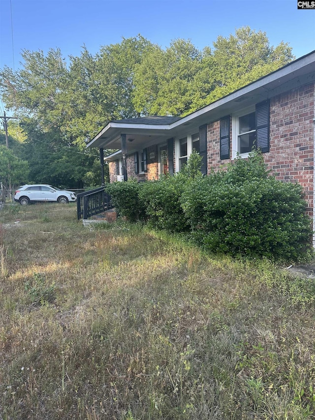 view of side of property featuring brick siding