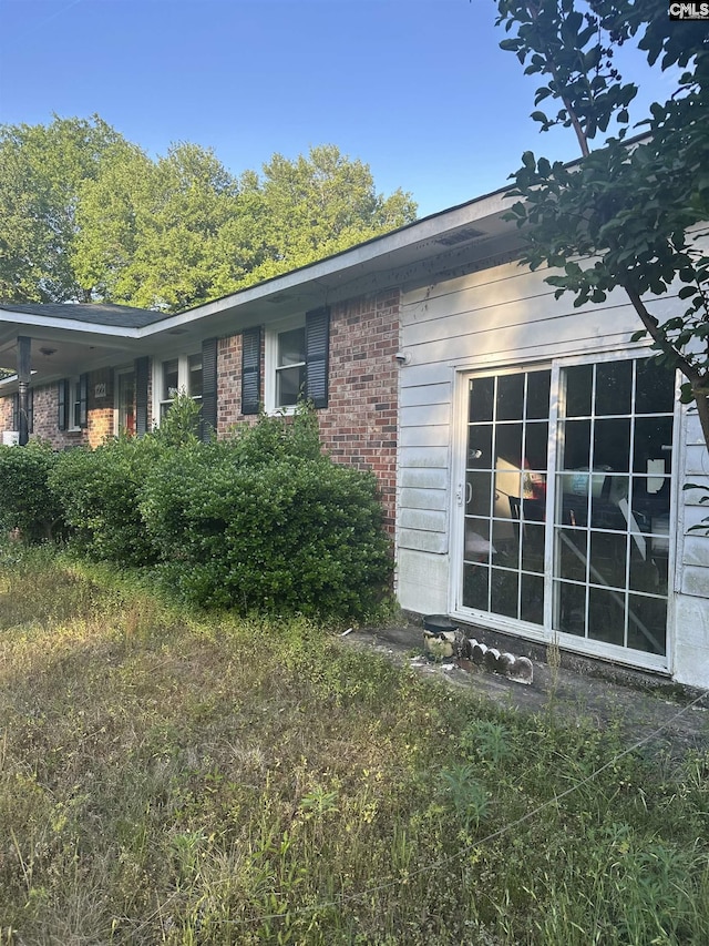 view of property exterior with brick siding