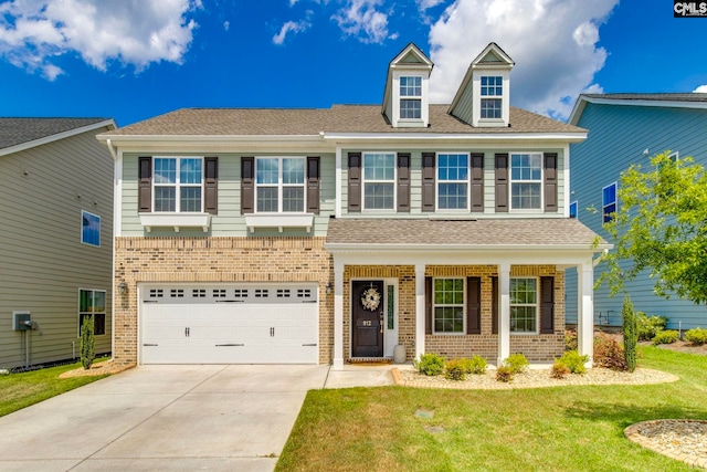 view of front of home with concrete driveway, brick siding, a front lawn, an attached garage, and a porch