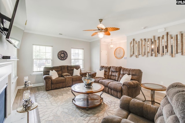 living room featuring a fireplace with flush hearth, wood finished floors, crown molding, ceiling fan, and baseboards