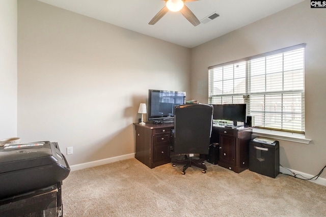 office space featuring ceiling fan, light carpet, and baseboards