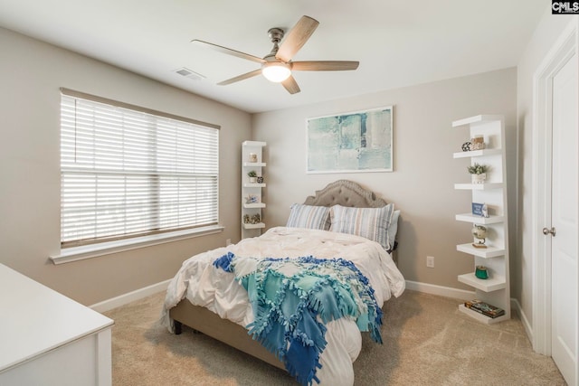 carpeted bedroom with baseboards and a ceiling fan