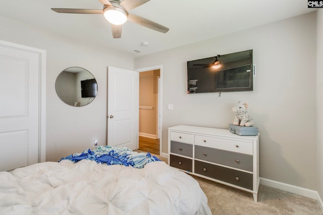 bedroom featuring baseboards, ceiling fan, and light carpet