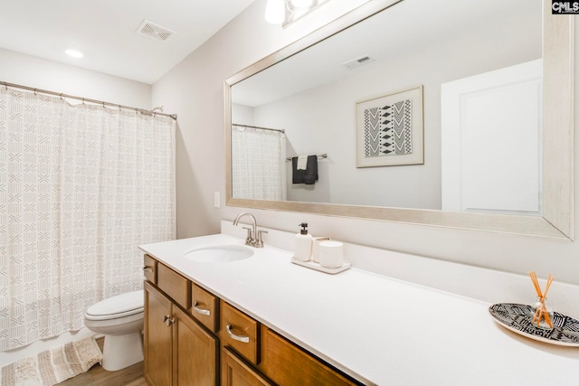 bathroom featuring toilet, vanity, curtained shower, and wood finished floors