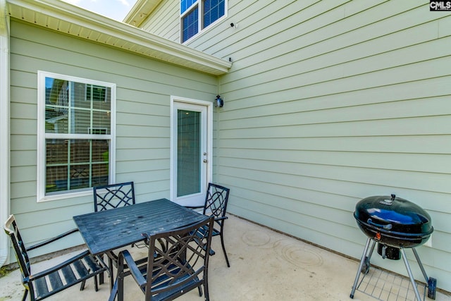 view of patio with area for grilling and outdoor dining area