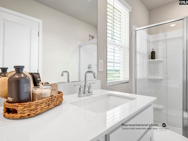 bathroom featuring plenty of natural light, a shower stall, and vanity