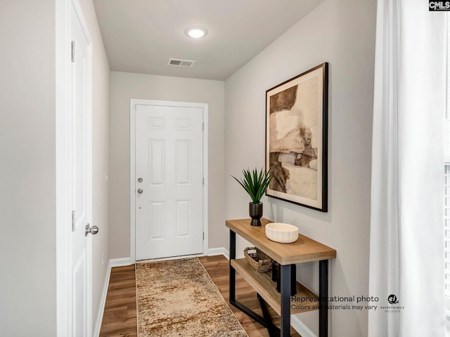 entryway with dark wood-style flooring and baseboards