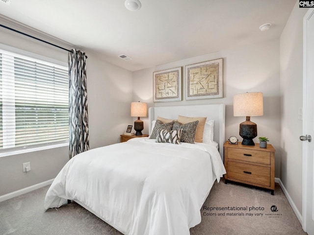 bedroom with carpet and baseboards