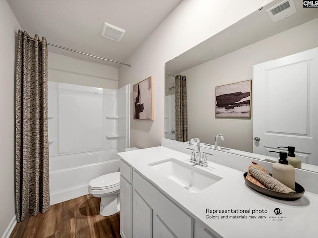 full bathroom with wood finished floors, toilet, vanity, and shower / tub combo with curtain