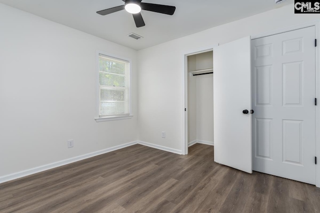 unfurnished bedroom featuring dark wood-style flooring, baseboards, ceiling fan, and a closet